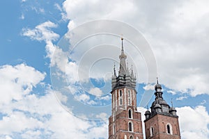 Gothic tower on a background of blue sky with clouds