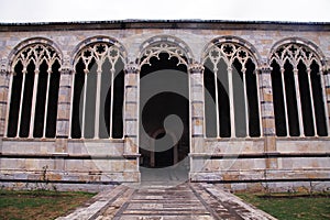 Gothic windows with traceries on Monumental cemetery Composanto, Pisa, Italy