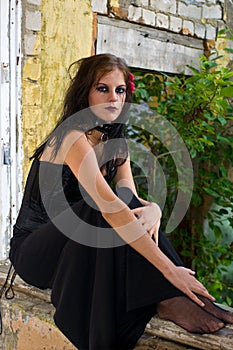 Gothic woman on windowsill