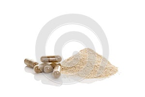 Gotu kola gel capsules and heap of powder.