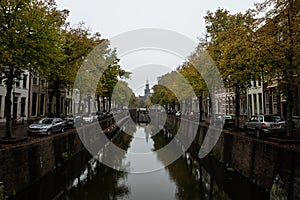 Gouda, South Holland/The Netherlands - September 28 2020: A view over the old canals in Gouda with in the distance the St. Jan