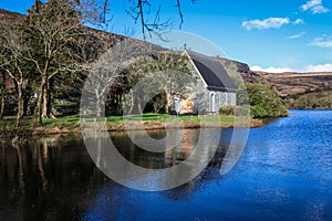 Gougane Barra, County Cork, Ireland, where water flows gracefully around a historic chapel