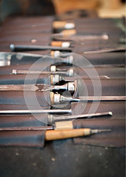 Gouges and chisels in the foreground leather case