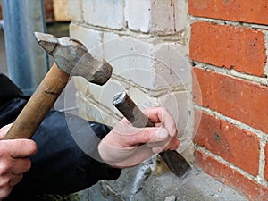 Gouging part of the foundation with hand tools