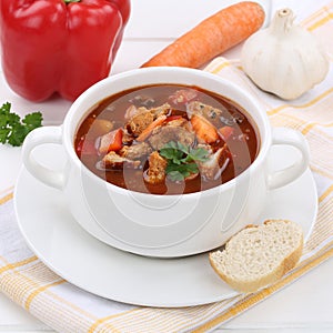 Goulash soup with meat, baguette and paprika healthy eating