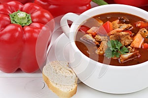 Goulash soup with meat and paprika in cup closeup