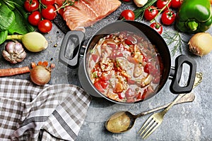 Goulash soup, salmon fillet and colorful vegetables