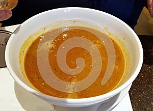 Goulash soup in white bowl.