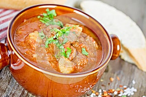 Goulash soup on wooden table