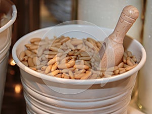 Goup of Pine Nuts inside White Container