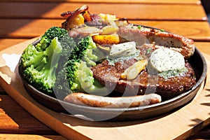 Gourmand pan with roasted meat,herbed butter,fried potatoes photo