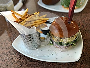 Gourmet Artisan Hamburger with French Fries on a Dining Table