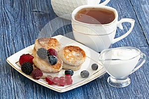 Gourmet Breakfast - Cottage cheese pancakes, syrniki, curd fritters with raspberry, strawberry, blueberry, BlackBerry