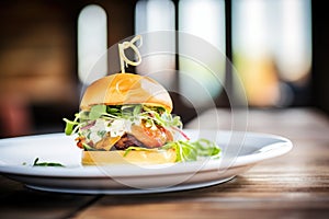 gourmet burger with arugula and goat cheese on a brioche bun