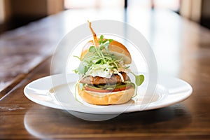 gourmet burger with arugula and goat cheese on a brioche bun