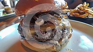 A gourmet burger piled high with caramelized onions avocado aioli and a dollop of black truffle mayo all served in a