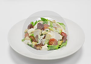 Gourmet Caesar Salad with Bacon. Top view. White background. Healthy eating concept