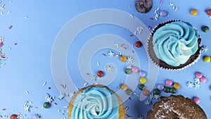 Gourmet colorful cupcakes topped with blue buttercream frosting
