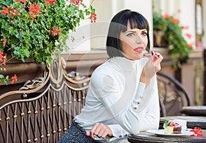 Gourmet concept. Girl relax cafe cake dessert. Pleasant time and relaxation. Delicious gourmet cake. Woman makeup face