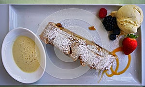 Gourmet Dessert on a Plate with Fruit, Ice Cream and Pastry