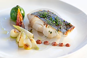 Gourmet fish fillet grilled with baby vegetables