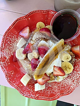 Gourmet French Toast Topped With Fresh Strawberries, Bananas, and a Dusting of Powdered Sugar