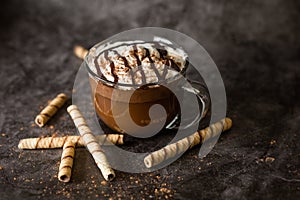 Gourmet Hot Chocolate in Glass Mug with Whipped Cream on a Dark Background