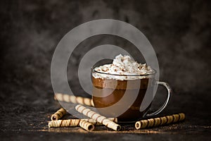 Gourmet Hot Chocolate in Glass Mug with Whipped Cream on a Dark Background