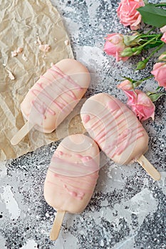 Gourmet ice cream dessert coconut-flavored iced chocolate glaze pink chocolate from a home bakery on gray background