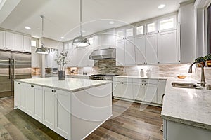 Gourmet kitchen features white cabinetry photo