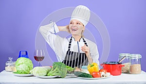 Gourmet main dish recipes. Girl in hat and apron. Delicious recipe concept. Cooking healthy food. Fresh vegetables