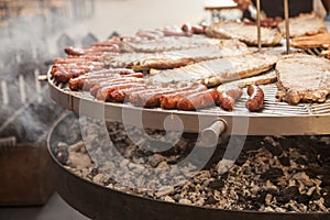 Gourmet meat pieces pork ribs, sausages, on a large grill .