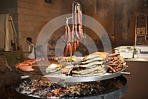 Gourmet meat pieces pork ribs, sausages, on a large grill .