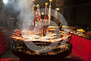 Gourmet meat pieces pork ribs, sausages, on a large grill .