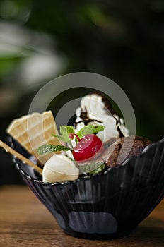 Gourmet organic chocolate and strawberry ice cream sundae dessert