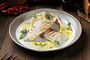 Pike perch fillet on couscous and bearnaise sauce photo