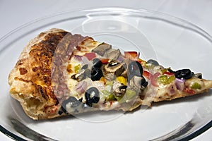 Gourmet pizza on clear glass dish