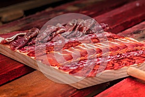 Gourmet plate of serrano ham jamon and sausage in Spain. Wooden plate