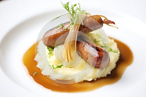 gourmet plating of bangers and mash with chives