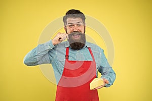 Gourmet product. Cheesemaking concept. Cheese maker. Bearded man in apron hold piece cheese. Dairy product derived from
