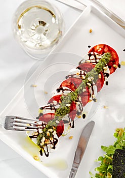 Gourmet, restaurant, delicious dinner food - close up of Caprese Salad. Salad with Tomatoes, Mozzarella Cheese, Balsamic. Salad Dr