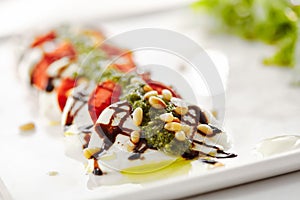 Gourmet, restaurant, delicious dinner food - close up of Caprese Salad. Salad with Tomatoes, Mozzarella Cheese, Balsamic. Salad Dr