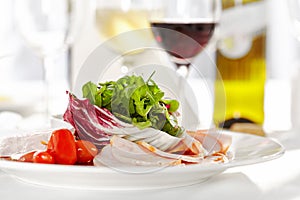 Gourmet, restaurant, delicious dinner food - close up of Sliced Meats with Rocket Salad and Tomatoes.