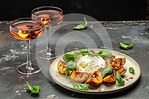 Gourmet Roasted Peaches with Burrata soft cheese, basil and drizzled with honey, with rose wine. Antipasto Dinner or aperitivo