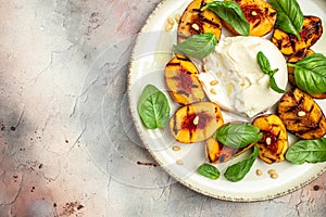 Gourmet Roasted Peaches with Burrata soft cheese, basil and drizzled with honey, with rose wine. Antipasto Dinner or aperitivo