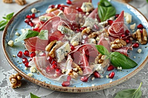 Gourmet salad with prosciutto, blue cheese, pomegranate, and walnuts