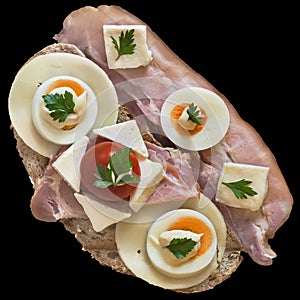 Gourmet Sandwich With Bacon Rashers Gammon Ham Cheese And Eggs Slices And Tomato Isolated On Black Background