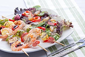 Gourmet shrimp skewers with salad greens