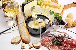 Gourmet Swiss fondue dinner on a winter evening with assorted ch