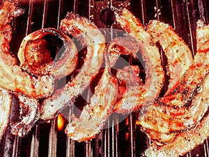 Gourmet thick cut pepper bacon on grill